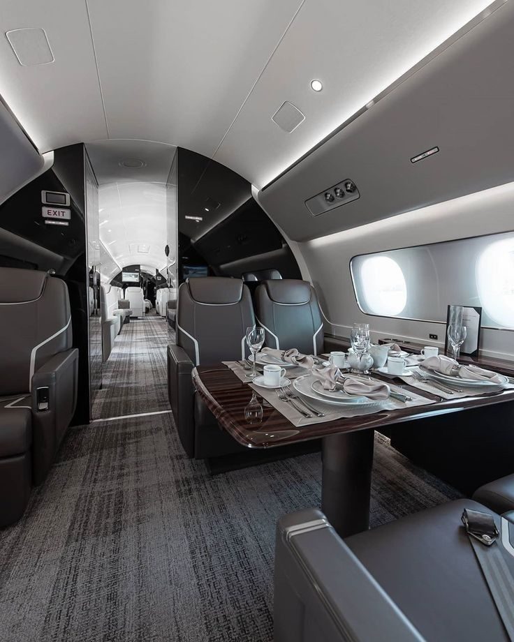 Cabin of a private jet with a dressed dining table